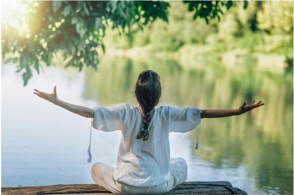 A woman sitting taking in the nature that surrounds her and envisioning the sustainability of the future.