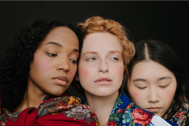 Three women of different races representing the beauty of the diversity that graces our planet.