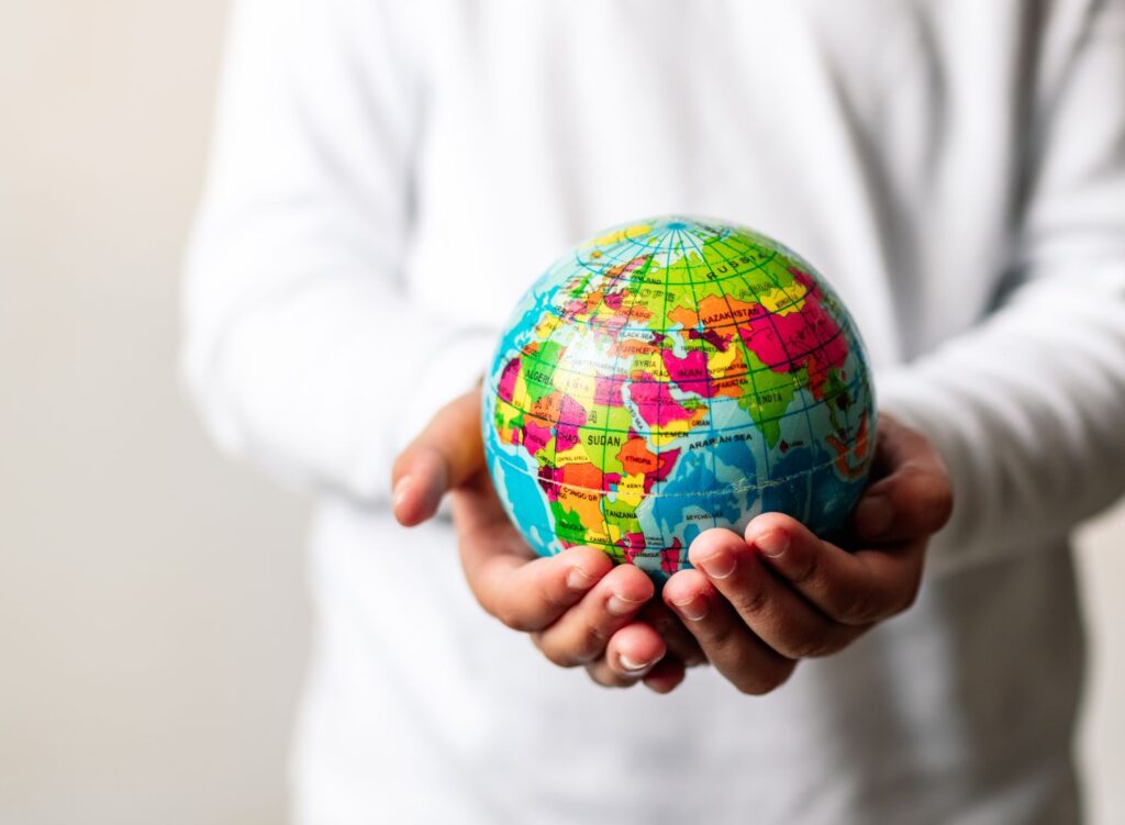 A man holding a miniature globe that we wish to sustain.